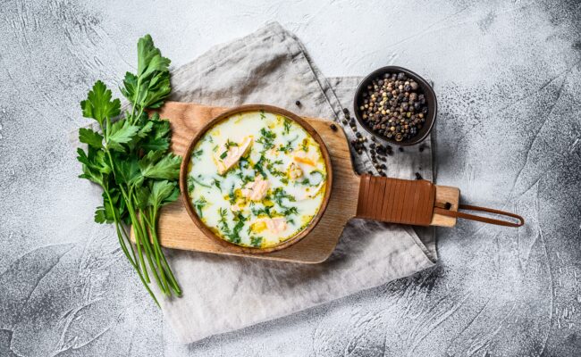 Finnish Creamy Fish Soup with Salmon and Potatoes.  Gray backgro