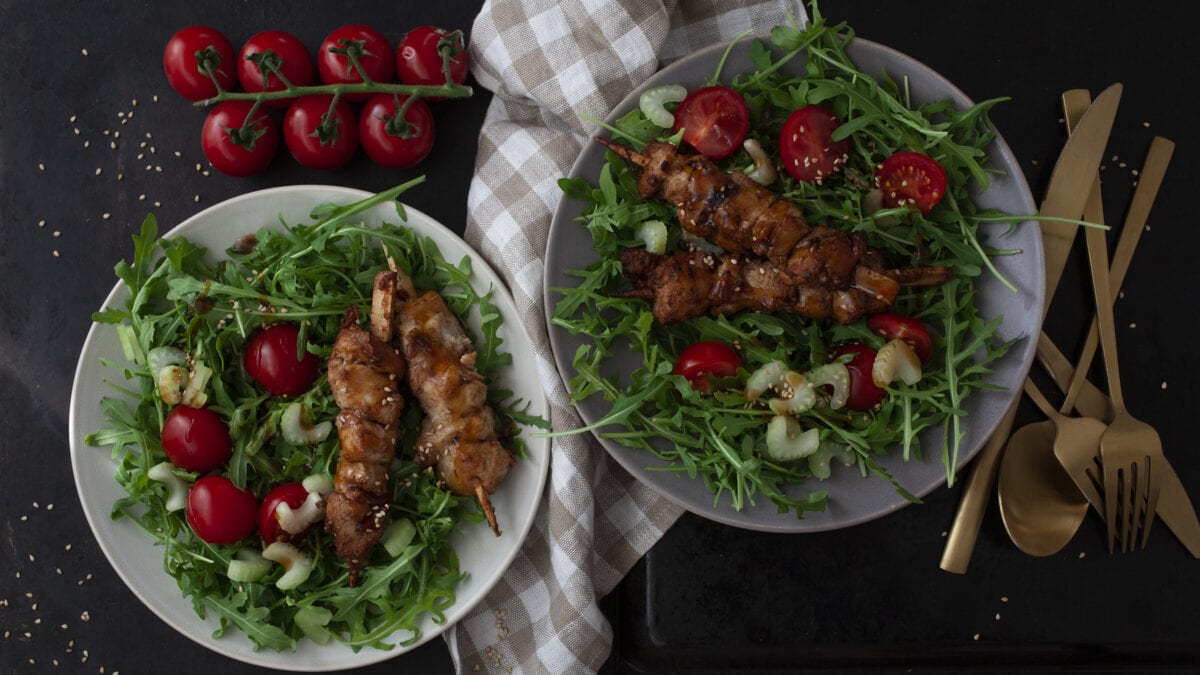 Marinede svinemørbrad på spyd på bund af frisk salat og broccoli